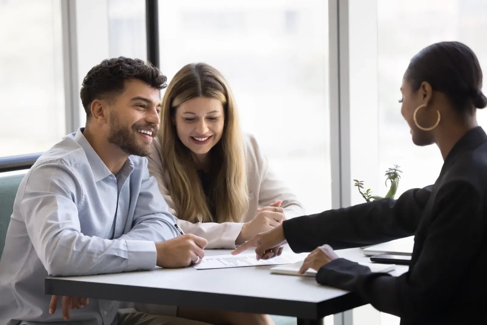 Couple discussing a financial agreement with an adviser
