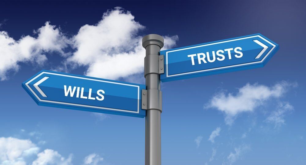 Signpost indicating directions for "Wills" and "Trusts," symbolizing choices in estate planning.